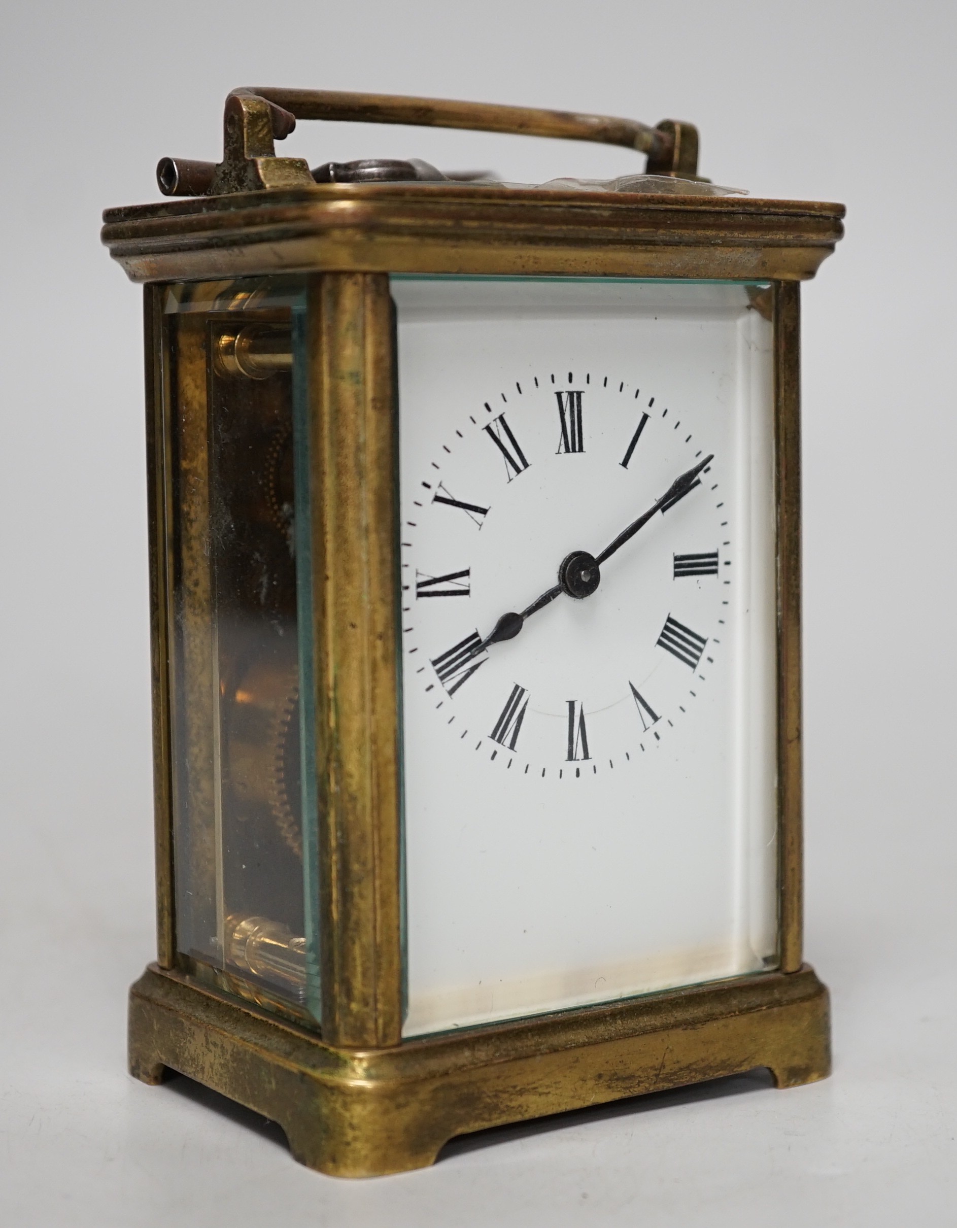 A 19th century brass carriage timepiece with black Roman numerals and second markers over a white dial